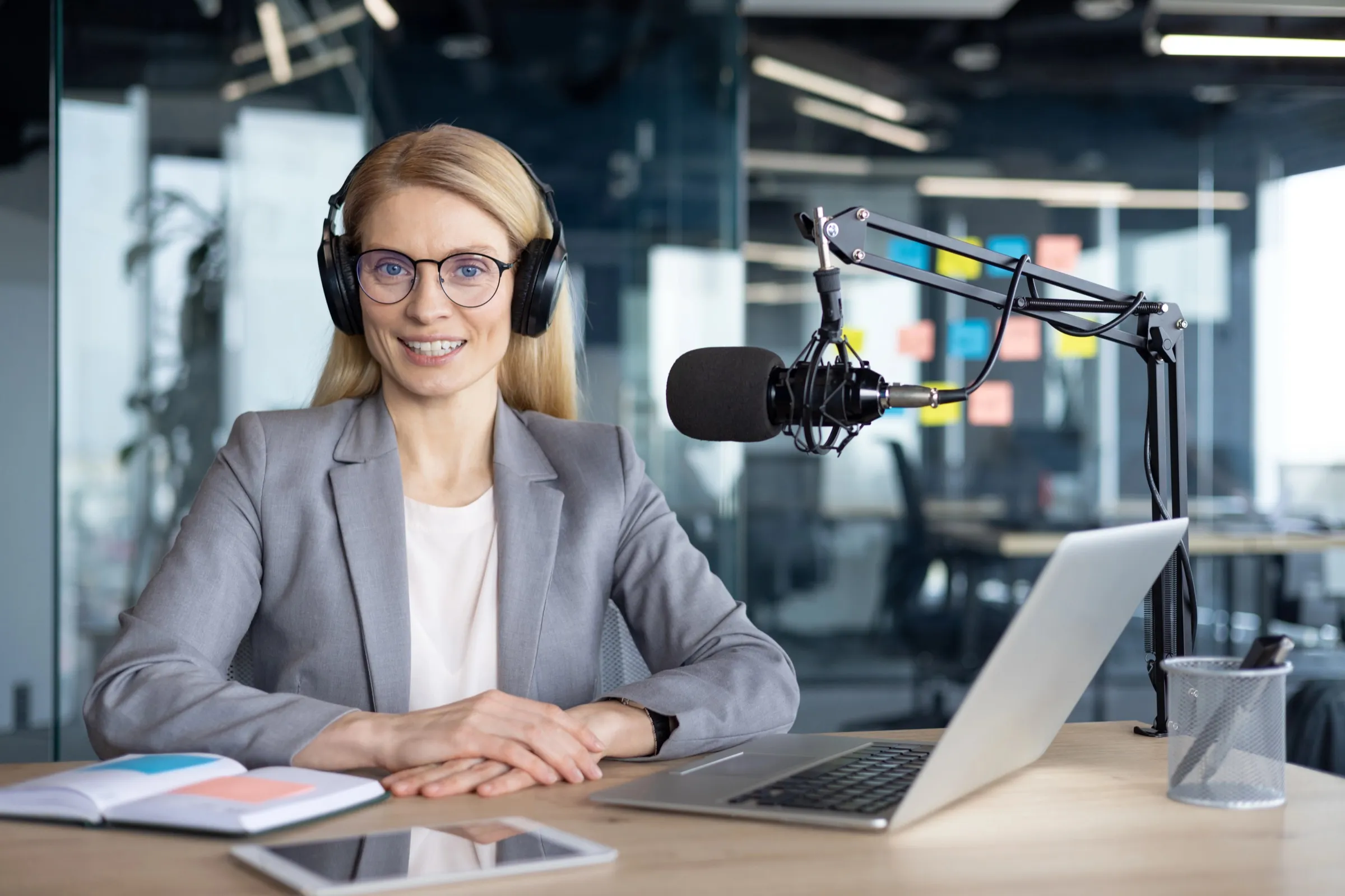 A professional recording a podcast from her office