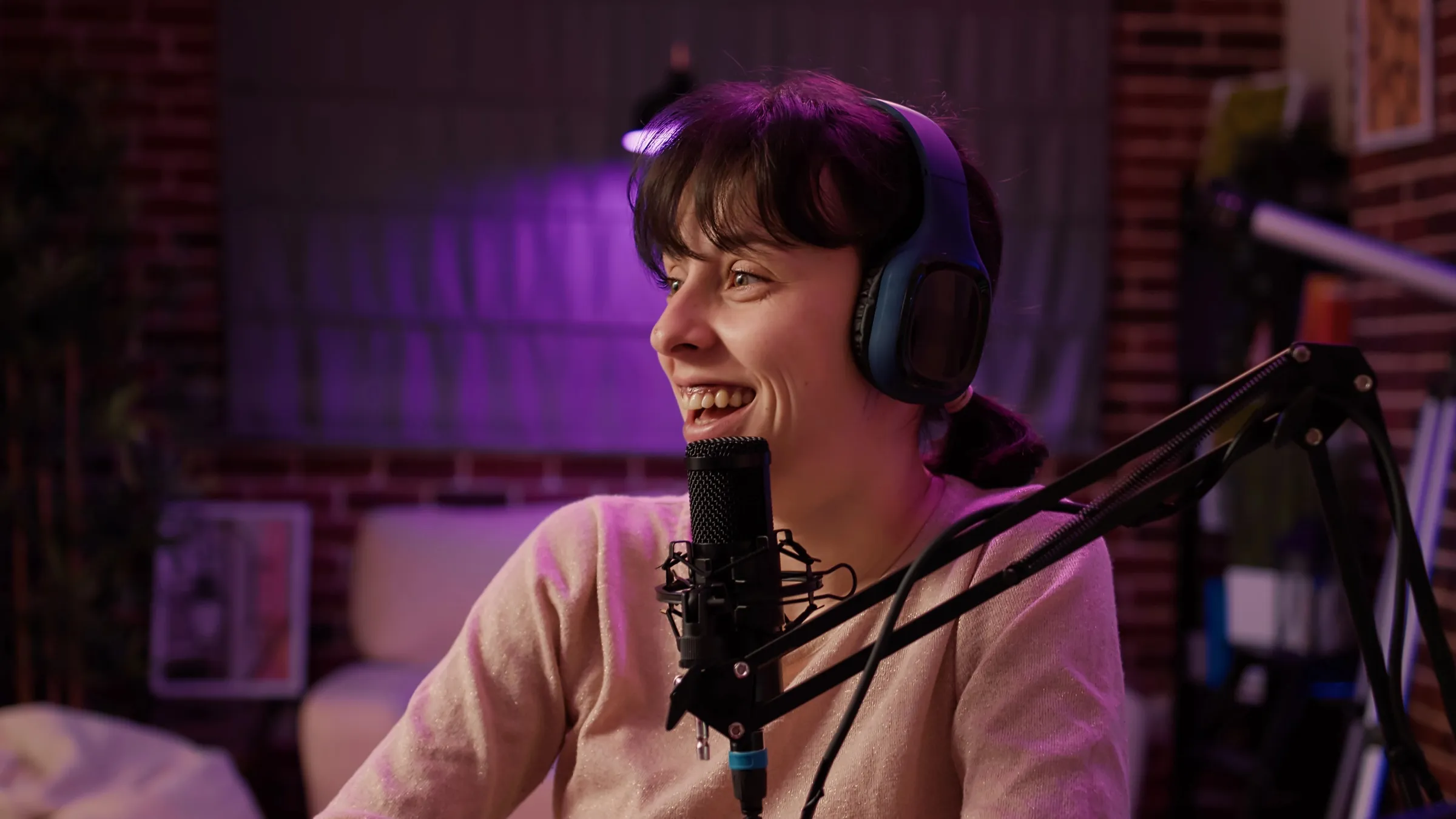 A host smiling at the microphone during a recording