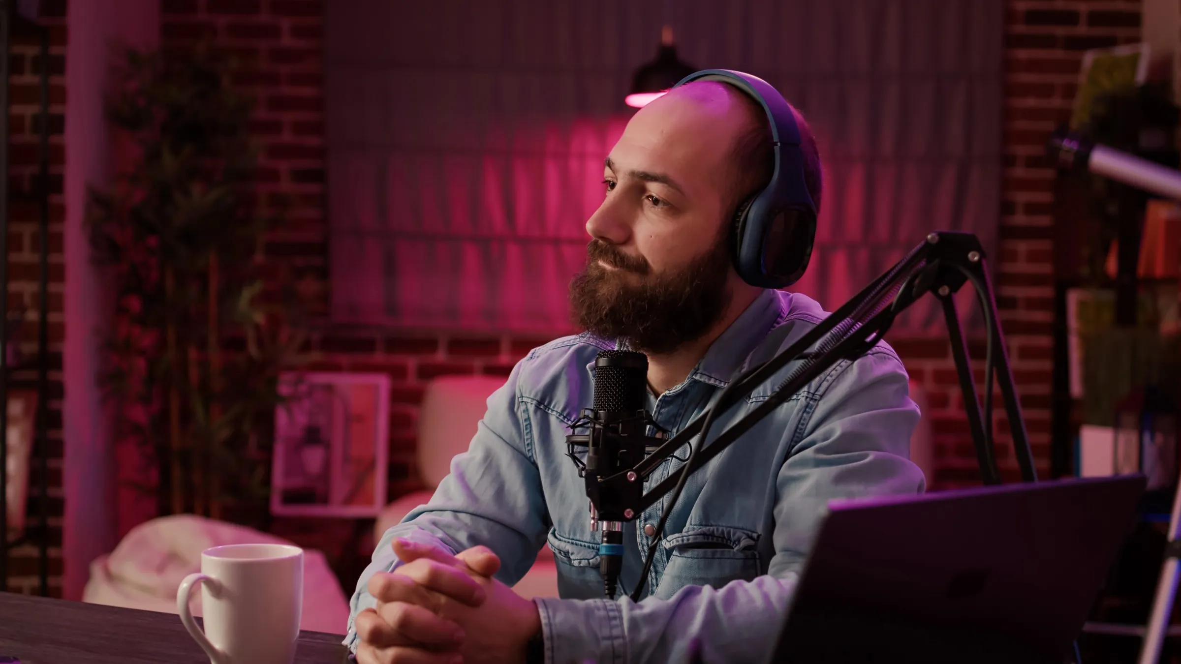 A coach listening to his guest in the studio